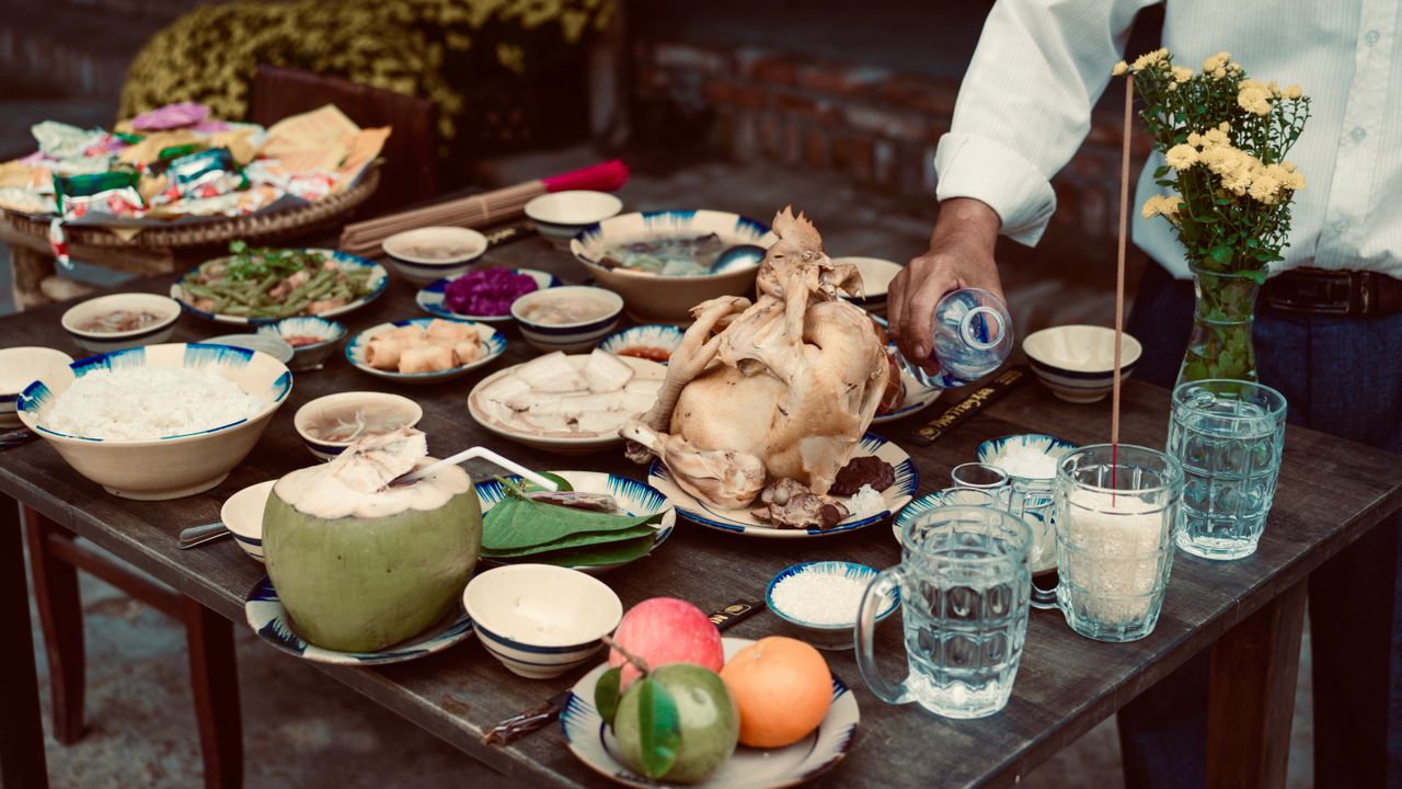 Table spread with fruit, rice and many shared dishes